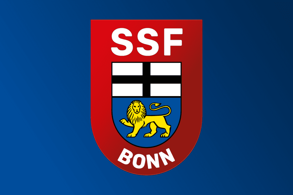 Logo des SSF Bonn mit rotem Schild, weißen Balken und einem gelben Löwen auf blauem Hintergrund.